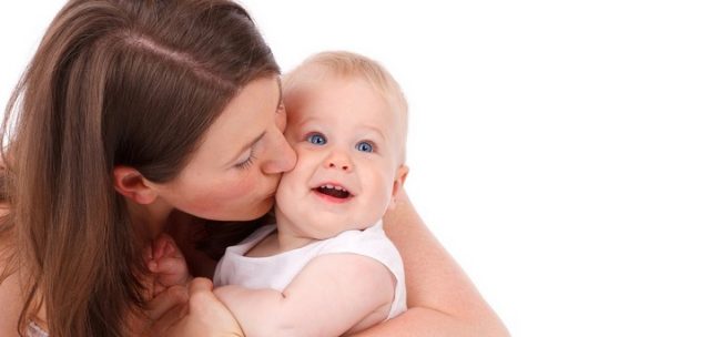 woman kissing baby